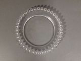 a glass plate with beads on it on a table