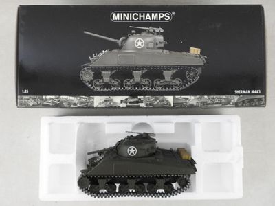a small toy tank in a plastic container on a table