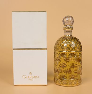 an image of a bottle of perfume sitting next to a box
