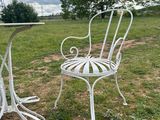 two chairs and a table in a field