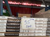 a stack of boxes with a sign on it in a warehouse