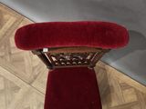 red velvet upholstered chair in the shape of a heart