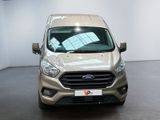 the front of a silver ford transit van parked in a showroom