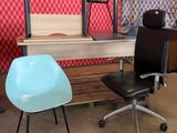 a desk with a chair and a computer on it