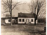 an old black and white photo of a house in the country