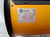 a close up of a yellow machine on a tiled floor