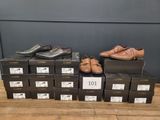 men ' s dress shoes in boxes on a wooden floor