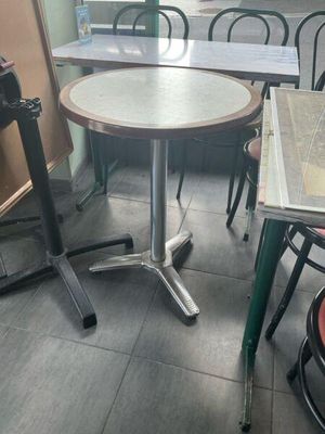 a table and chairs in a restaurant with a window in the background