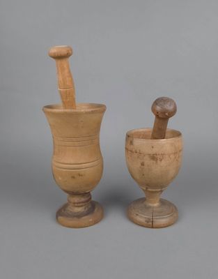 un mortier et un pilon en bois sur fond gris