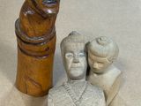 a statue of a man and a woman next to a statue of a man