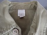 a close up of a buttoned shirt with a tag on it