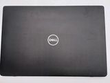 the dell laptop is sitting on a white surface with a black cover