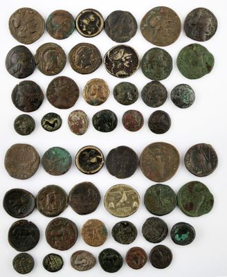 a collection of ancient roman coins on a white surface