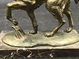 bronze statue of a man on a horse on a marble base