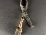 a close up of a small pipe with a metal handle