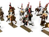 several figurines of men in uniforms riding horses on a white surface