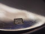 a close up of a silver plate with a square design on it