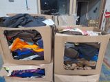 two boxes with clothes in them sitting on the floor