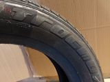 a close up of a tire on the ground with a box in the background