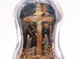 a bottle with a picture of jesus on the cross inside of it