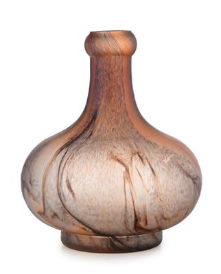 a glass vase that is sitting on a white surface