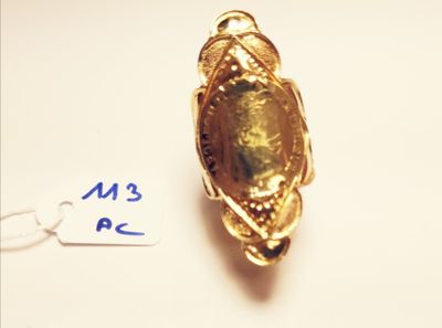 a gold ring with a green stone in it
