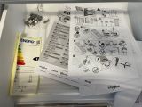 a lot of papers that are sitting on top of a refrigerator