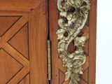 a wooden cabinet with a marble top and a door handle