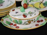 a plate with a lid that has a bunch of berries on it