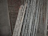 a lot of metal racks in a room with a brick wall