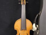 an old violin sits next to a guitar case on a black background