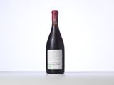 a bottle of red wine sitting on top of a table