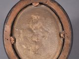a brown plate with a picture of a woman on it