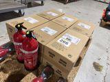 several boxes of fire extinguisors sitting on top of a pile of cardboard