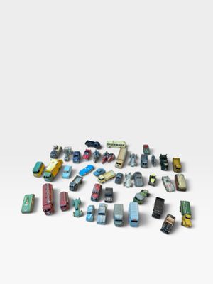 a lot of toy cars that are on a white surface