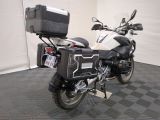 a motorcycle parked in a garage with a box on the back of it