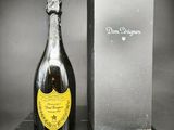 une vieille bouteille de champagne posée à côté d'une boîte sur une table