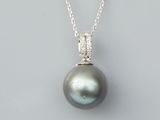 a black pearl and diamond pendant on a silver chain