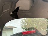 a hole in the rear window of a car that has been smashed
