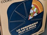 a box of pizza sitting on top of a pile of boxes