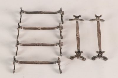 several pieces of metal are arranged on a white surface