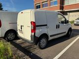 two vans parked in a parking lot next to each other