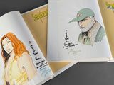three books that are open on a table