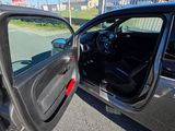 a car that has its door open on the side of the road