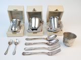 four silverware pieces in a wooden box with a spoon and spoon rest