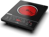 a close up of a black and red stove top on a white surface