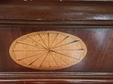 a clock that is on the side of a piano