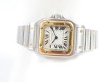 a close up of a watch on a white surface