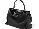 a black leather handbag with a zipper closure and a metal handle