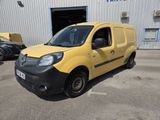 a yellow van parked in front of a building in a parking lot